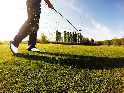 高尔夫球手执行一个高尔夫球杆从球道.