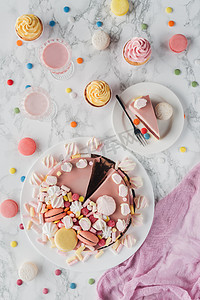 nutrition摄影照片_flat lay with birthday cake, marshmallows, candies, sweet cupcakes and milkshakes