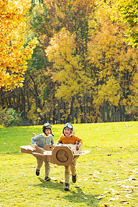黄色可爱摄影照片_两个男孩玩开飞机游戏