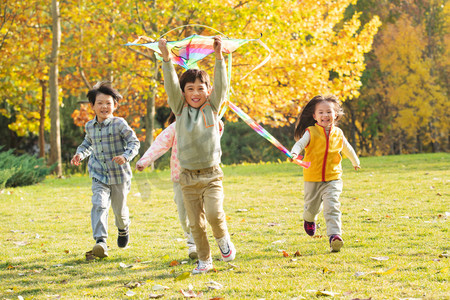 追逐奔跑摄影照片_快乐的小朋友在公园里放风筝