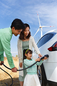 新能源充电桩图片摄影照片_快乐家庭给汽车充电