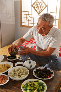 白酒现代摄影照片_老年人坐在家里吃饭喝酒