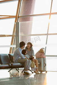 座位图片摄影照片_一家三口坐在机场候机大厅