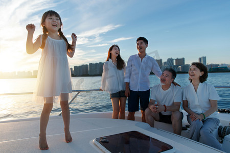夕阳下在游艇上的快乐一家人