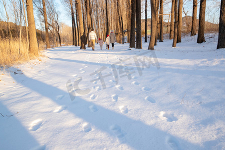 快乐家庭在雪地里散步