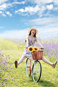 在花海里骑自行车的快乐女人