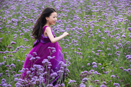 天真摄影照片_快乐的小女孩在花海里奔跑