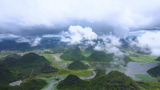 云南旅游房价摄影照片_航拍云南普者黑云雾缭绕田园风景