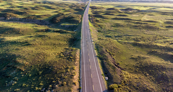 塞北大草原摄影照片_航拍草原上的公路摄影图配图