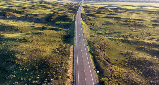 道路风景图摄影照片_航拍草原上的公路摄影图配图