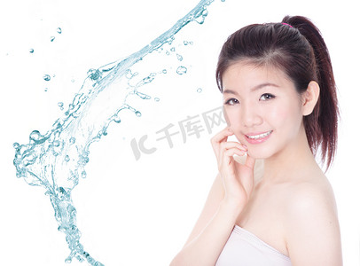 飞溅的水摄影照片_年轻女子微笑的脸护肤与飞溅的水