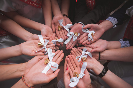 classmates hold hands together with bells last day at school