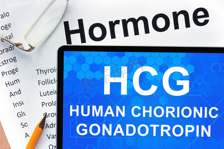 papers摄影照片_Papers with hormones list and tablet  with words  Human chorionic gonadotropin (HCG) .