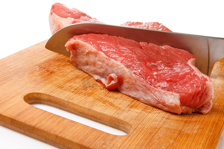 特写厨师切肉摄影照片_刀和肉