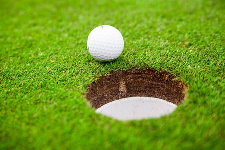 Golf ball on green meadow