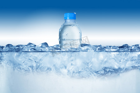 矿泉水瓶摄影照片_在冰块中的冷矿泉水瓶。
