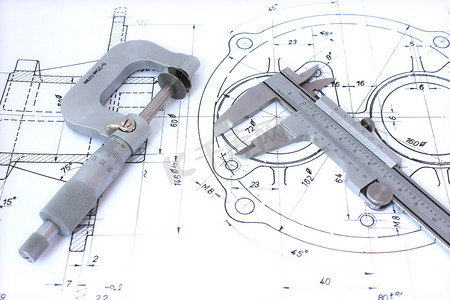 制定计划摄影照片_千分尺和制动钳上的蓝图