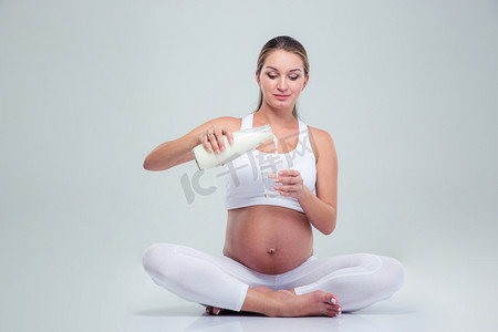 Woman sitting on the floor and drinking milk