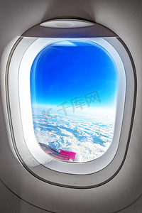 Airplane Porthole Window and Summer Clouds