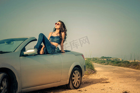 年轻的女人坐在一辆车