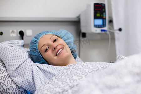 Young woman in hospital recovery room after surgery