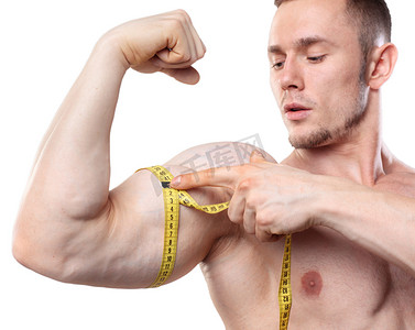 Image of muscular man measure his biceps with measuring tape in centimeters. Isolated on white backgound