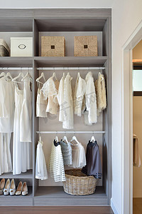 粉紅色礼服摄影照片_行的白色礼服和鞋子挂在衣柜现代衣柜