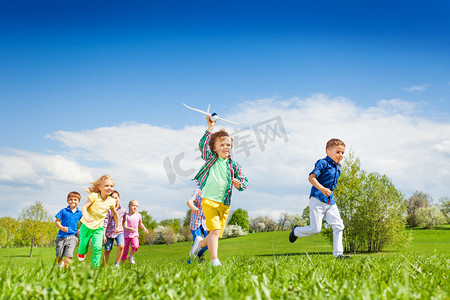 Running boy with airplane toy and children