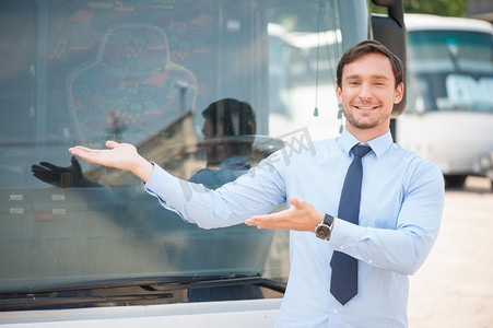 advertising摄影照片_Cheerful young man is advertising a public transport