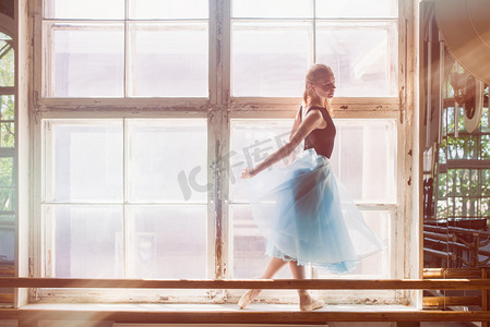 在一个大窗口面前跳舞芭蕾舞女演员