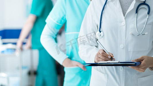 在医院工作的医务人员: 医生和护士检查病人的病历记录在剪贴板上, 医疗保健和医学考试的概念