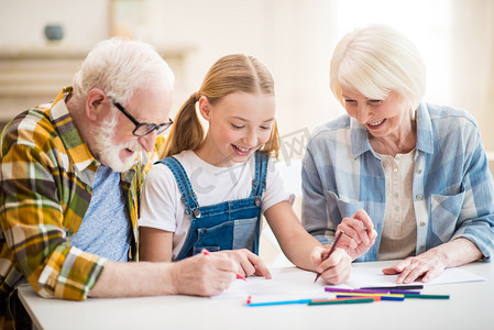 Girl with grandparents drawing