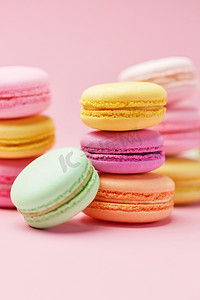 糖果。马卡龙关门五颜六色的甜甜点在柔和的粉红色背景。高分辨率