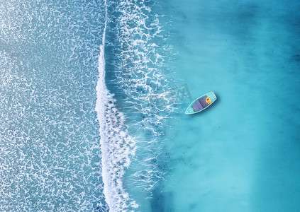 夏季时漂浮在蔚蓝海洋中的小船鸟瞰图 