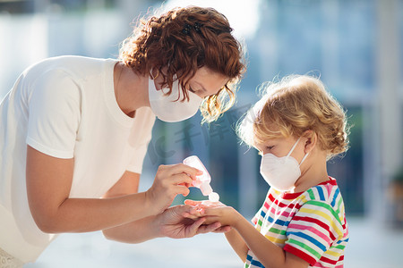 发烧购物摄影照片_Mother and child with face mask and hand sanitizer