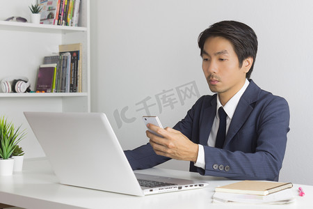 Asian Financial Advisor or Asian Consulting Businessman Contact with Customer by Smartphone