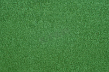 fabric摄影照片_Large texture of bright green artificial leather, background.