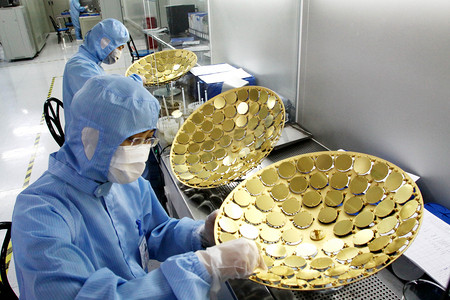 Workers manufacture LED chips in the clean room at the plant of Shandong Inspur Huaguang Optoelectronics Co., Ltd. in Weifang city, east Chinas Shandong province, 27 June 2011
