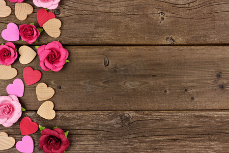 双12侧边栏摄影照片_情人节侧边木心和纸玫瑰对一个质朴的木材背景与复制空间.