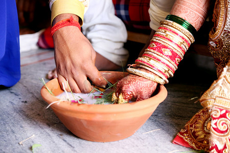 印度婚礼摄影照片_印度夫妇在婚礼上玩环鱼游戏
