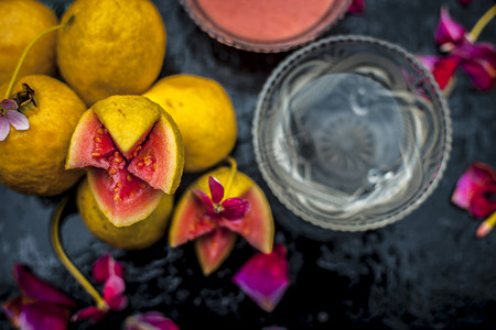 Guava face mask for glowing skin on a wooden surface with a blurred background consisting of some guava pulp well mixed with water.