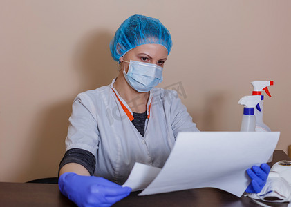 A female doctor in a sterile mask and uniform on a break after prevention during the covid-19 coronavirus pandemic