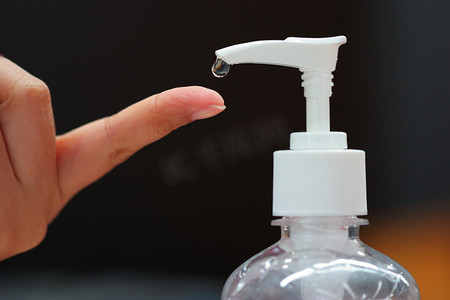 受保护摄影照片_在医疗保健概念中，当人们为了保护自己不受细菌和白种人感染而伸出手来的时候，用酒精凝胶瓶洗手.