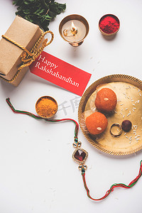 Raksha Bandhan / Rakshabandhan Rakhi with Haldi Kumkum rice, sweet Mithai, Gift Box, selective focus