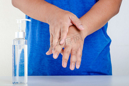手掌手背摄影照片_用酒精洗手放入手掌，在手掌上揉搓。手背和手指头直到酒精蒸发，直到干涸。Coronavirus预防概念.