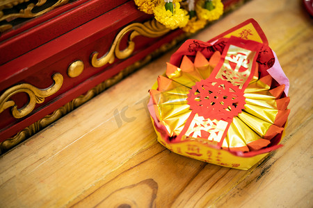 ghost摄影照片_Golden chinese folded paper ghost and gods for burning, Ghost and gods money offering in the temple in Chinese temple.