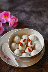 tangyuan摄影照片_Tangyuan, Wolfberry and flowers on the table