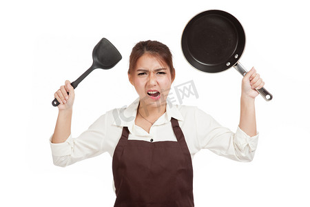 疯狂工作摄影照片_疯狂的亚洲女孩用油炸锅做饭