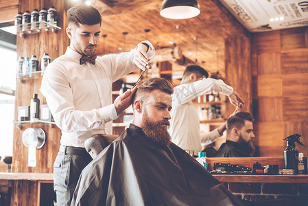 young bearded man with hairdresser