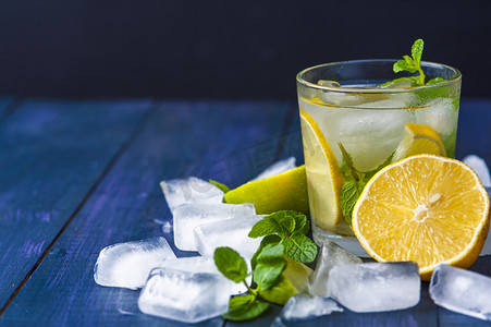 Glass of lemonade with mint leaves and ice cubes